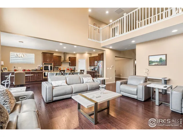 a kitchen with stainless steel appliances kitchen island granite countertop a table chairs sink and cabinets