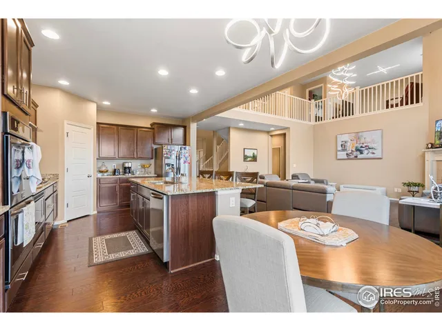 a dining room with furniture a chandelier and wooden floor
