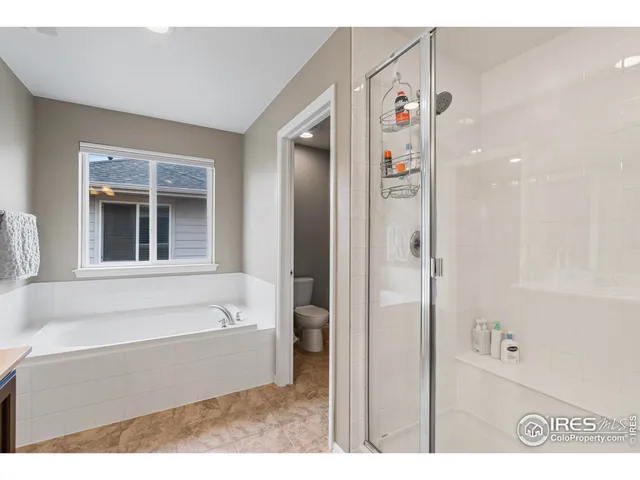 a view of walk in closet with clothes