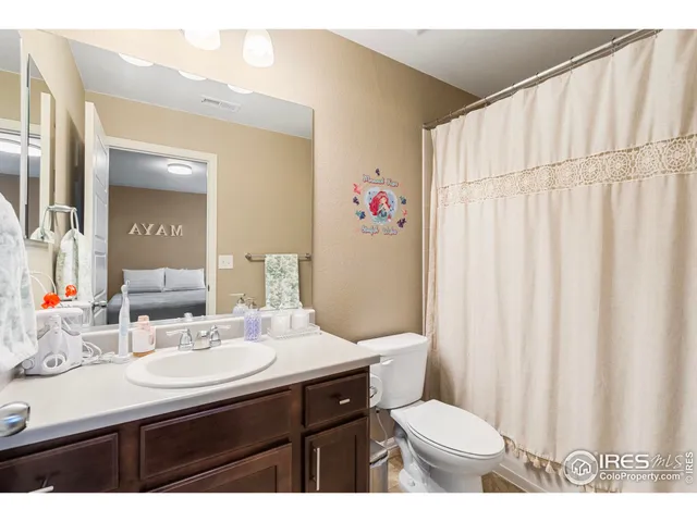 a view of walk in closet with clothes