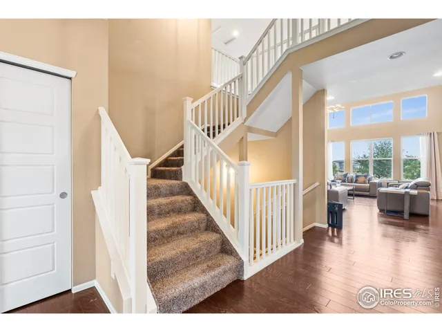 a living room with furniture a large window and a fireplace