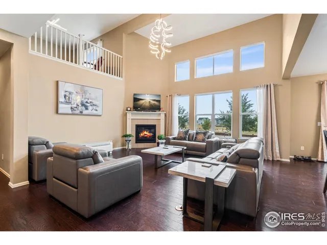 a living room with furniture a fireplace and a wall painting