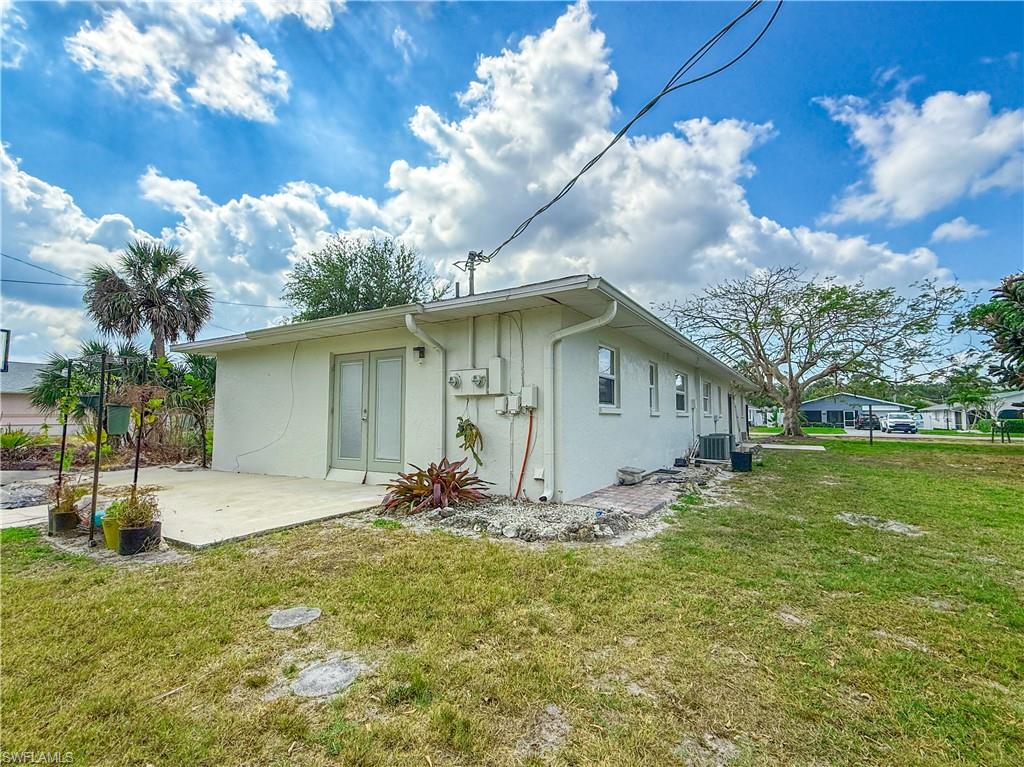 593 92nd Avenue North, Unit A & B Naples, FL 34108 - Photo 2 of 6 a front view of house with yard and trees