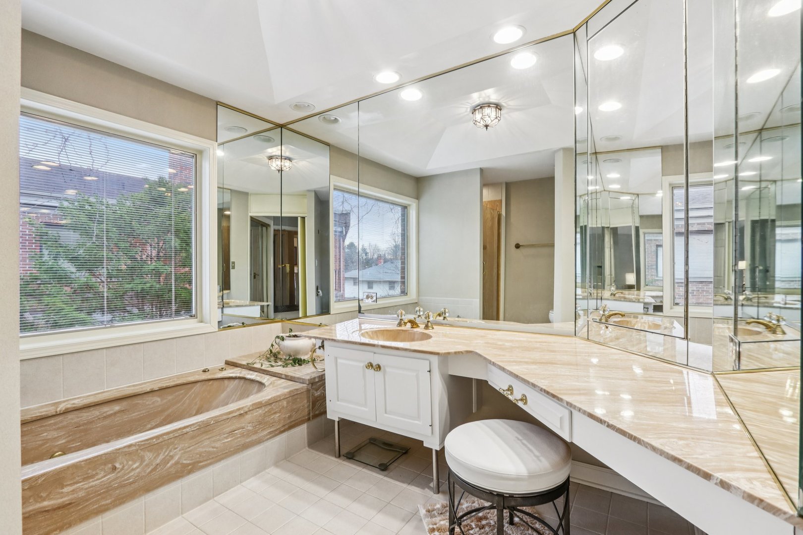 19 Landmark Street, Unit 19 Northfield, IL 60093 - Photo 26 of 50 a bathroom with a granite countertop sink mirror bathtub and toilet