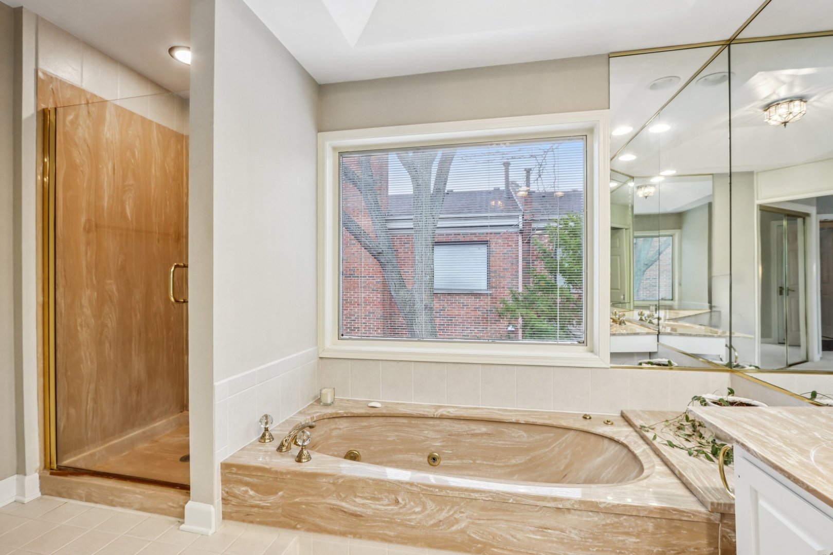 19 Landmark Street, Unit 19 Northfield, IL 60093 - Photo 27 of 50 a bathroom with a granite countertop tub and a sink