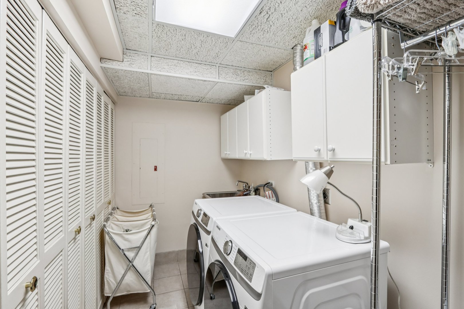 19 Landmark Street, Unit 19 Northfield, IL 60093 - Photo 36 of 50 a utility room with cabinets washer and dryer