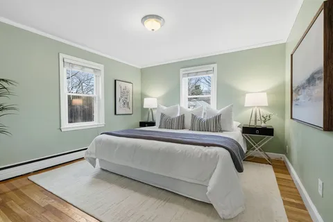 a bed room with a bed window and a night stand