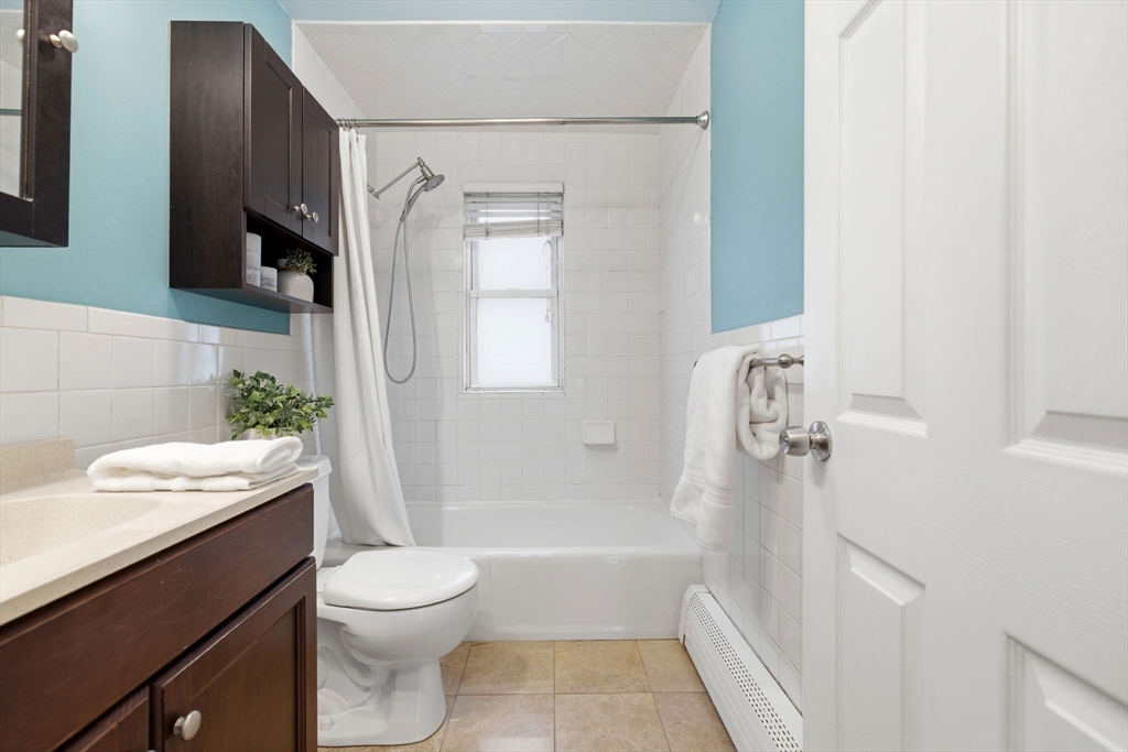 5 Baker Street Boston, MA 02132 - Photo 18 of 40 a bathroom with a sink a toilet and shower