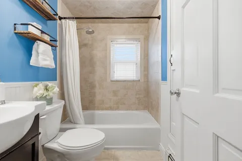 a bathroom with a toilet and a bathtub