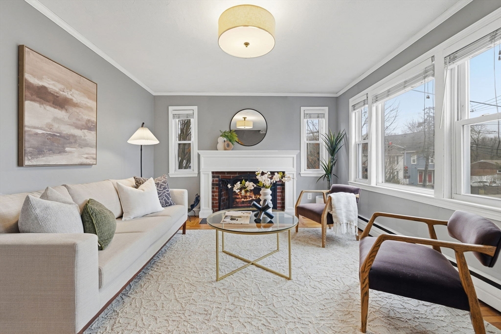 5 Baker Street Boston, MA 02132 - Photo 2 of 40 a living room with furniture a fireplace and a large window