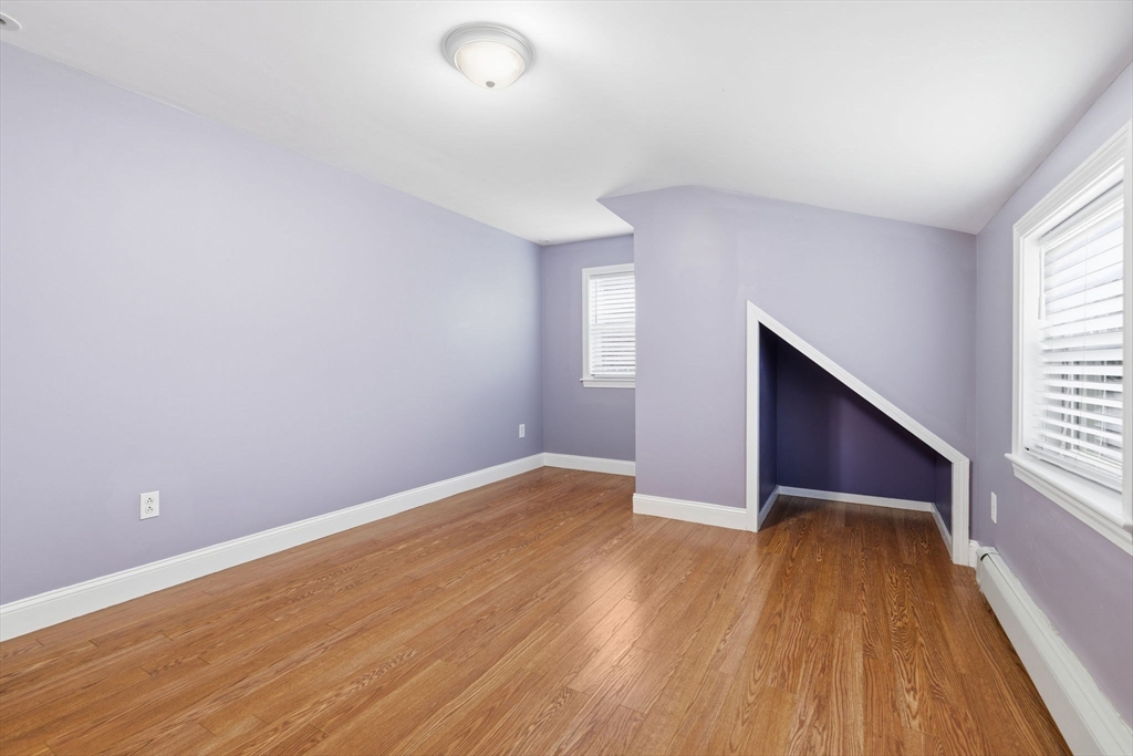 5 Baker Street Boston, MA 02132 - Photo 21 of 40 an empty room with wooden floor and windows