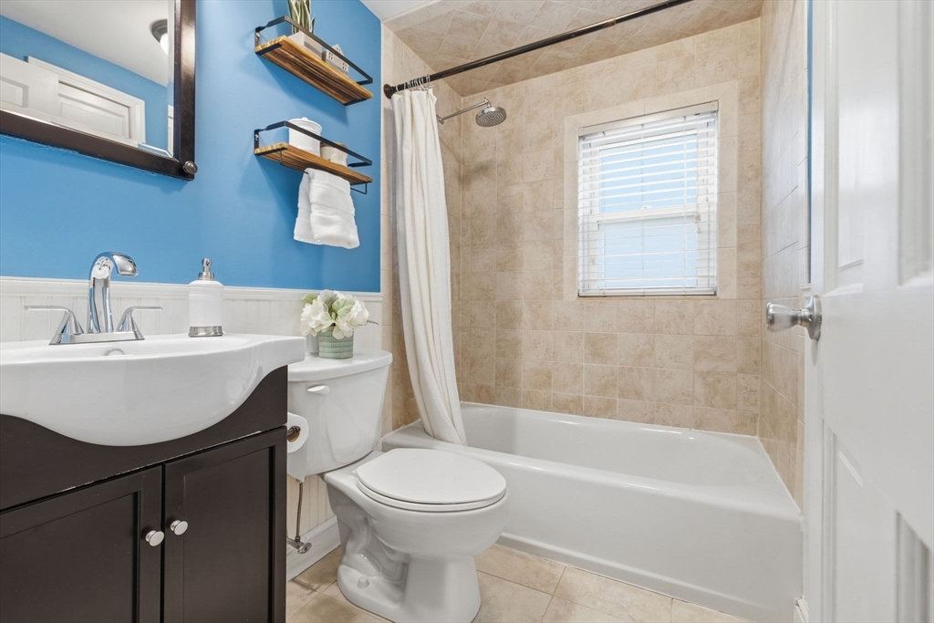 5 Baker Street Boston, MA 02132 - Photo 25 of 40 a bathroom with a sink a toilet and shower