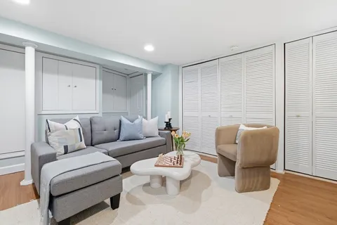 a living room with furniture and a potted plant