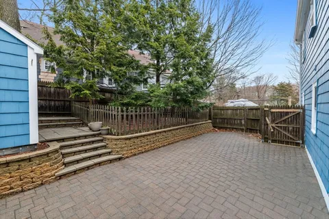 a view of backyard with wooden deck and seating space