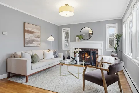 a living room with furniture a window and a fireplace