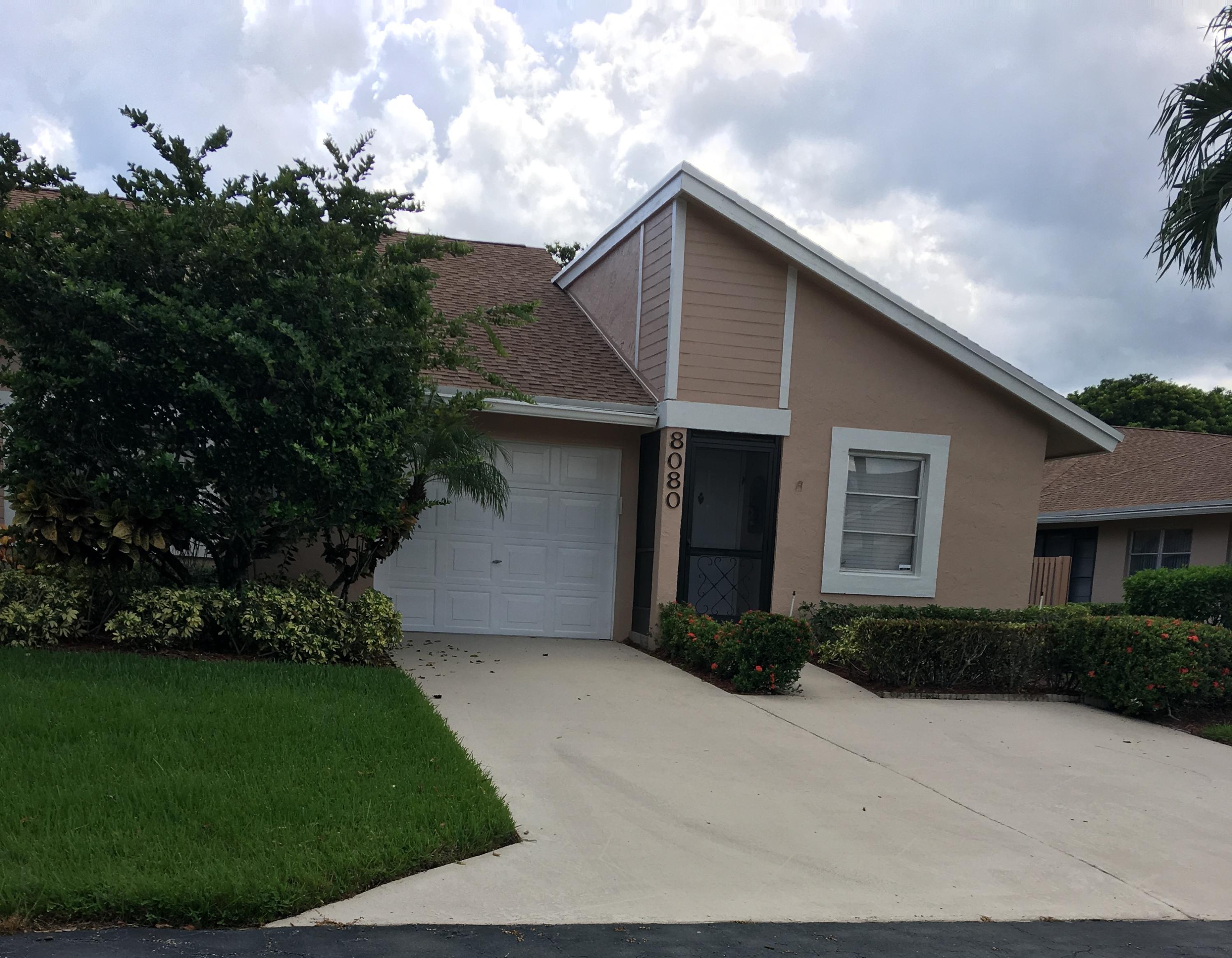 8080 Sweetbriar Way, Unit B Boca Raton, FL 33496 - Photo 1 of 14 a front view of a house with a garden