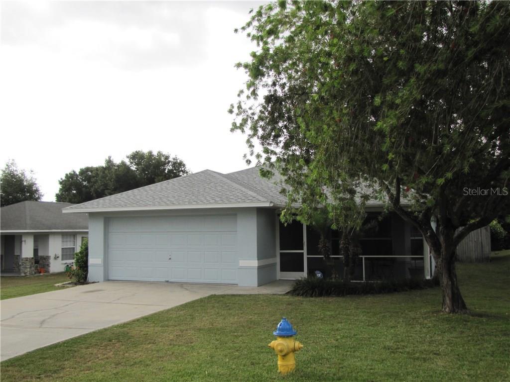 84 Tyler Road Winter Haven, FL 33884 - Photo 1 of 1 a front view of a house with garden