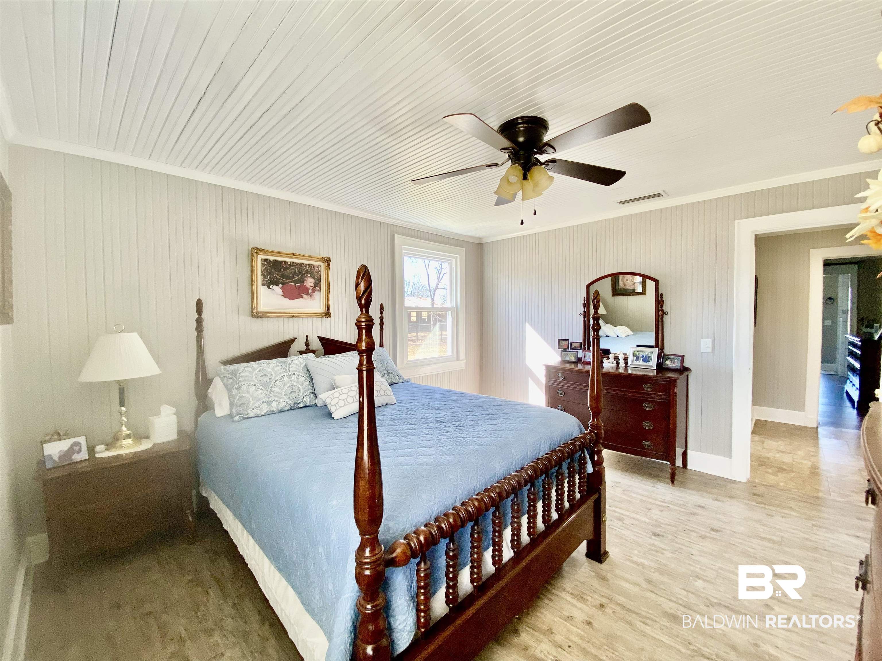 2711 County Road 5 Repton, AL 36475 - Photo 16 of 36 Bedroom with ceiling fan, light hardwood / wood-style floors, and crown molding