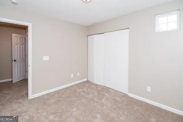 an empty room with closet area