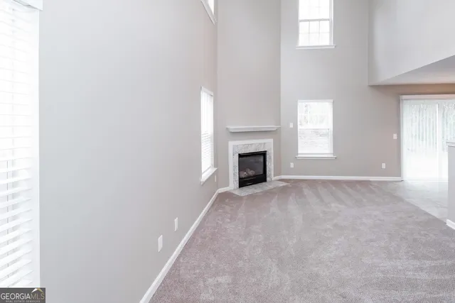 a view of empty room with a fireplace