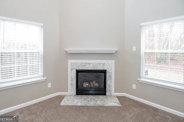 a living room with a fireplace and a window