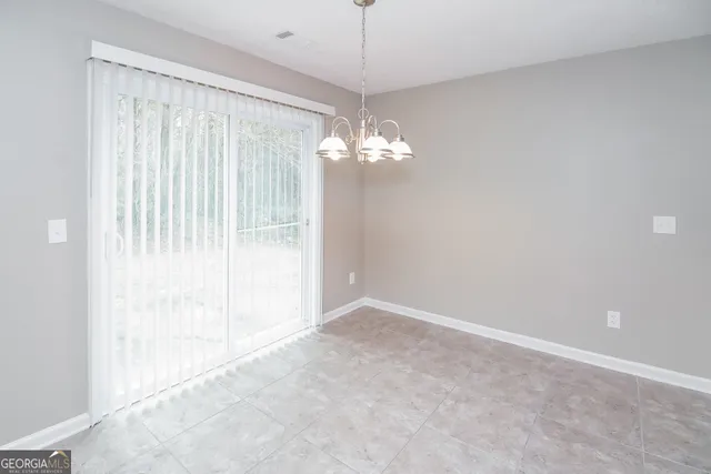 a view of a chandelier in big room and chandelier