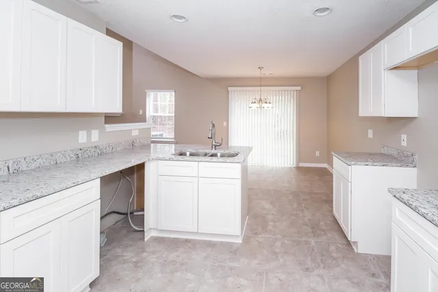 a kitchen with a sink stove and cabinets