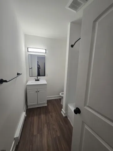 a bathroom with a sink a mirror and shower