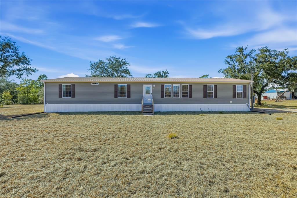 5530 Northeast 103rd Terrace Bronson, FL 32621 - Photo 1 of 29 a view of a house with a backyard