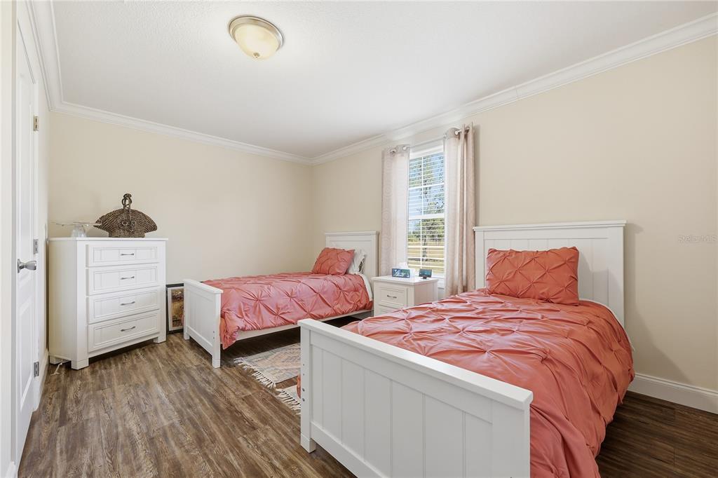 5530 Northeast 103rd Terrace Bronson, FL 32621 - Photo 11 of 29 a bedroom with a bed and wooden closet
