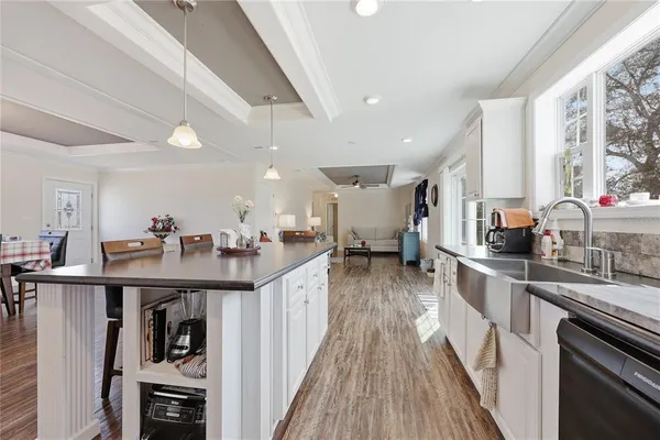 a kitchen with stainless steel appliances a sink stove and cabinets