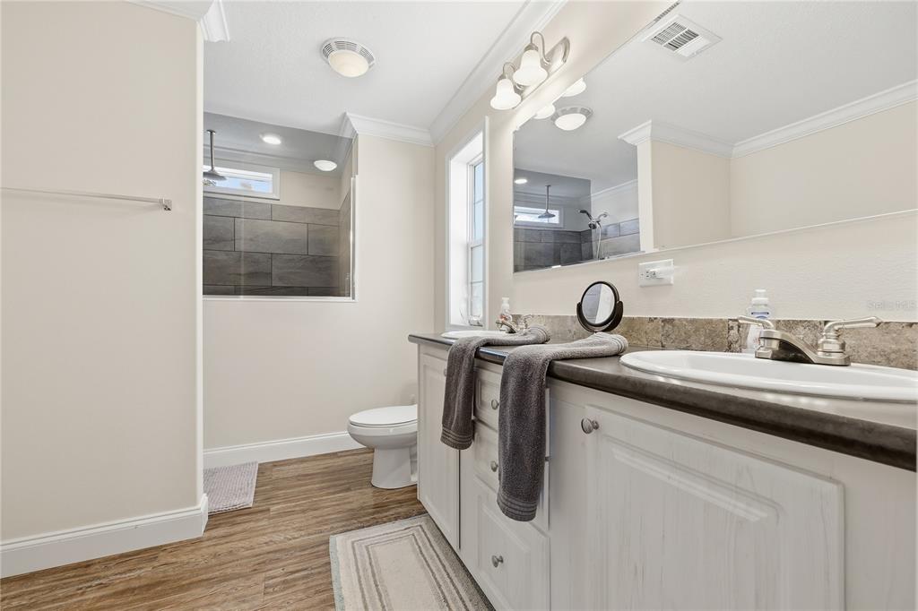 5530 Northeast 103rd Terrace Bronson, FL 32621 - Photo 7 of 29 a bathroom with a sink a toilet and shower