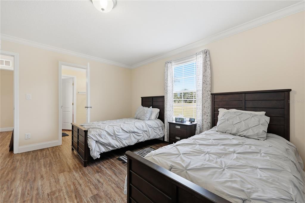 5530 Northeast 103rd Terrace Bronson, FL 32621 - Photo 9 of 29 a bedroom with two beds and a large window