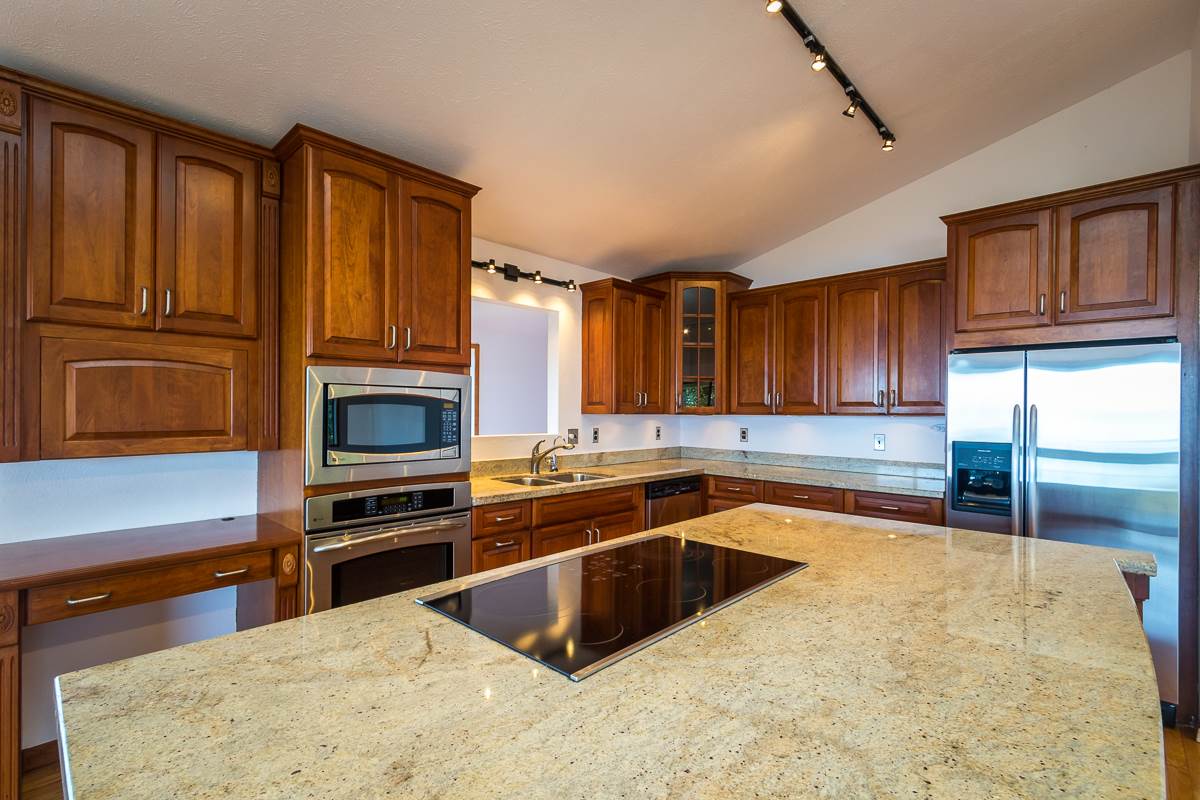 395 Middle Road Kula, HI 96790 - Photo 18 of 30 a kitchen with stainless steel appliances granite countertop a stove a sink and a microwave