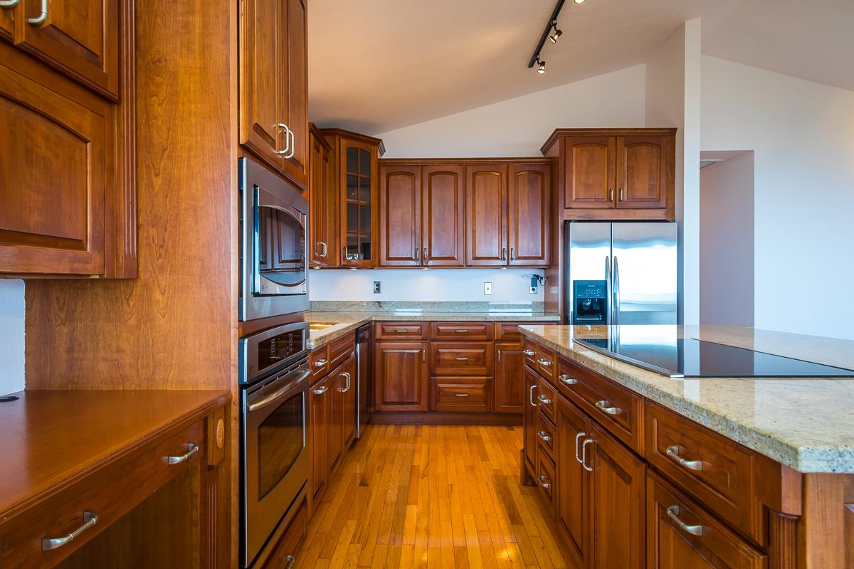 395 Middle Road Kula, HI 96790 - Photo 19 of 30 a kitchen with stainless steel appliances granite countertop a stove a sink and a microwave