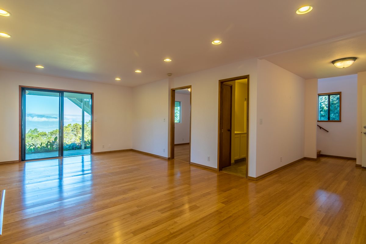 395 Middle Road Kula, HI 96790 - Photo 22 of 30 a view of an empty room with wooden floor and windows