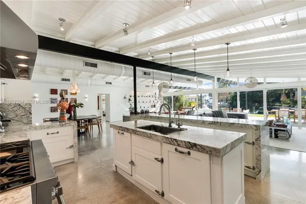 a kitchen with stainless steel appliances granite countertop a sink and cabinets