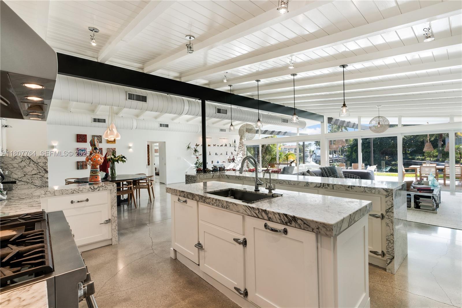 270 Island Drive Key Biscayne, FL 33149 - Photo 1 of 19 a kitchen with stainless steel appliances granite countertop a sink and cabinets
