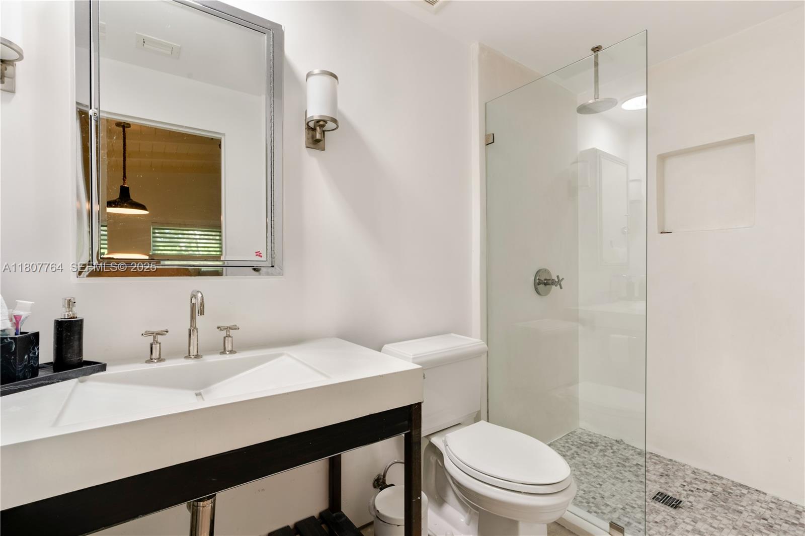 270 Island Drive Key Biscayne, FL 33149 - Photo 15 of 19 a bathroom with a toilet a sink a mirror a vanity and shower