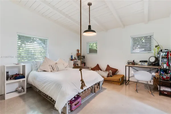 a bedroom with bed and a window