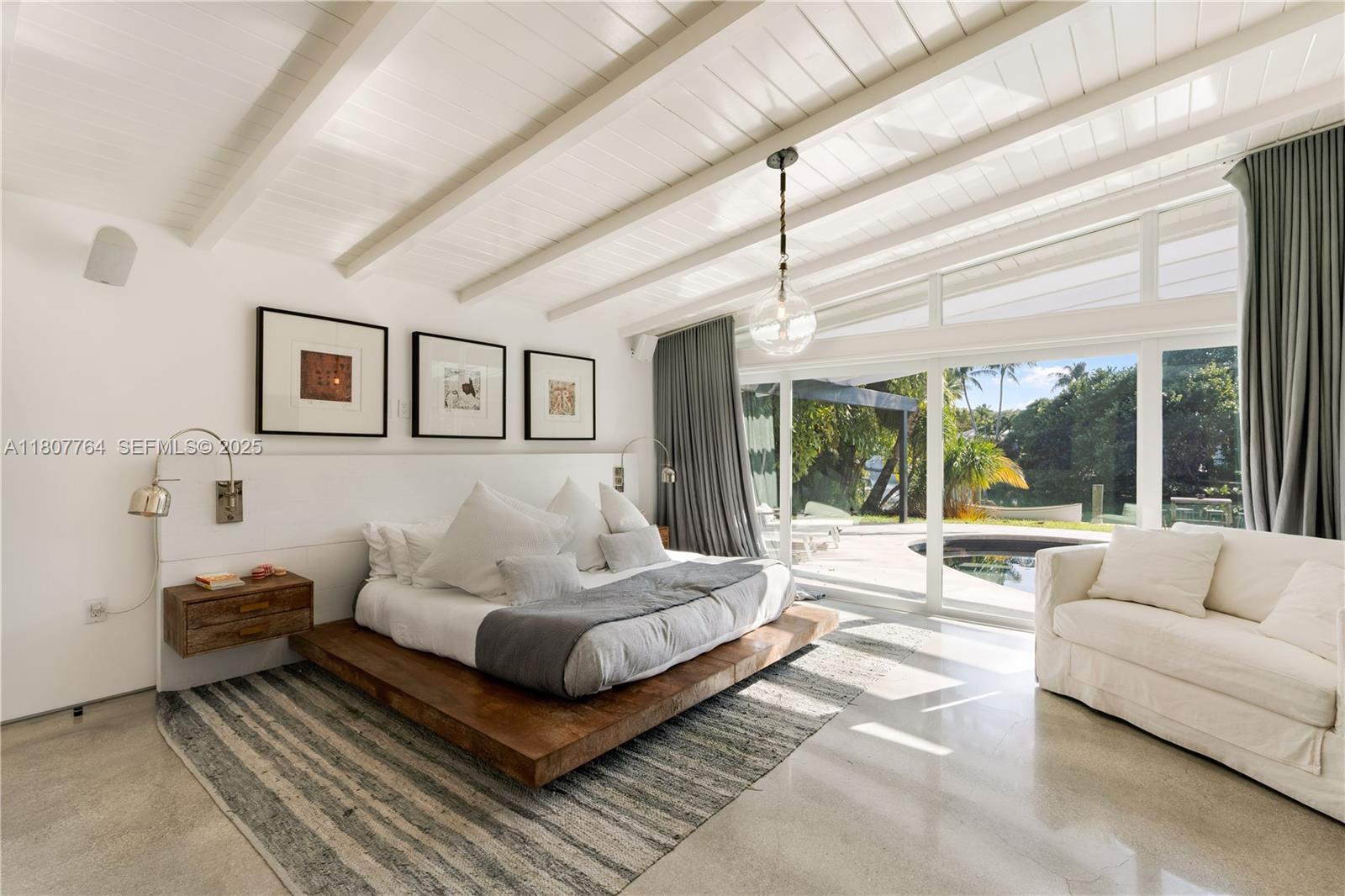 270 Island Drive Key Biscayne, FL 33149 - Photo 4 of 19 a spacious bedroom with a large bed and a large window