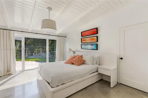 a bedroom with a large bed and a large window