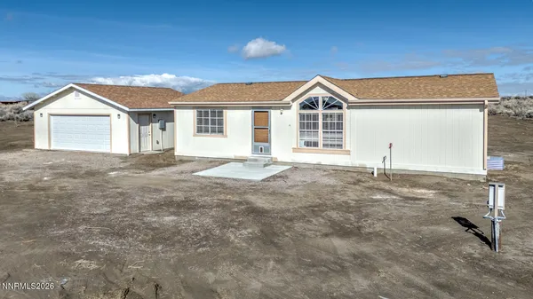 a view of a house with a yard and garage