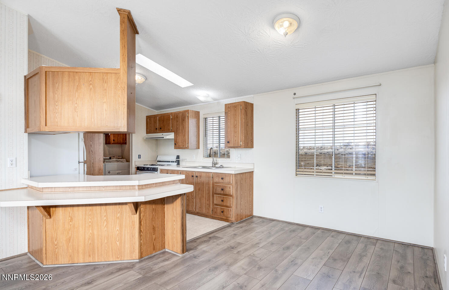 6312 Sierra Way Fallon, NV 89406 - Photo 6 of 20 a kitchen with a sink cabinets and wooden floor