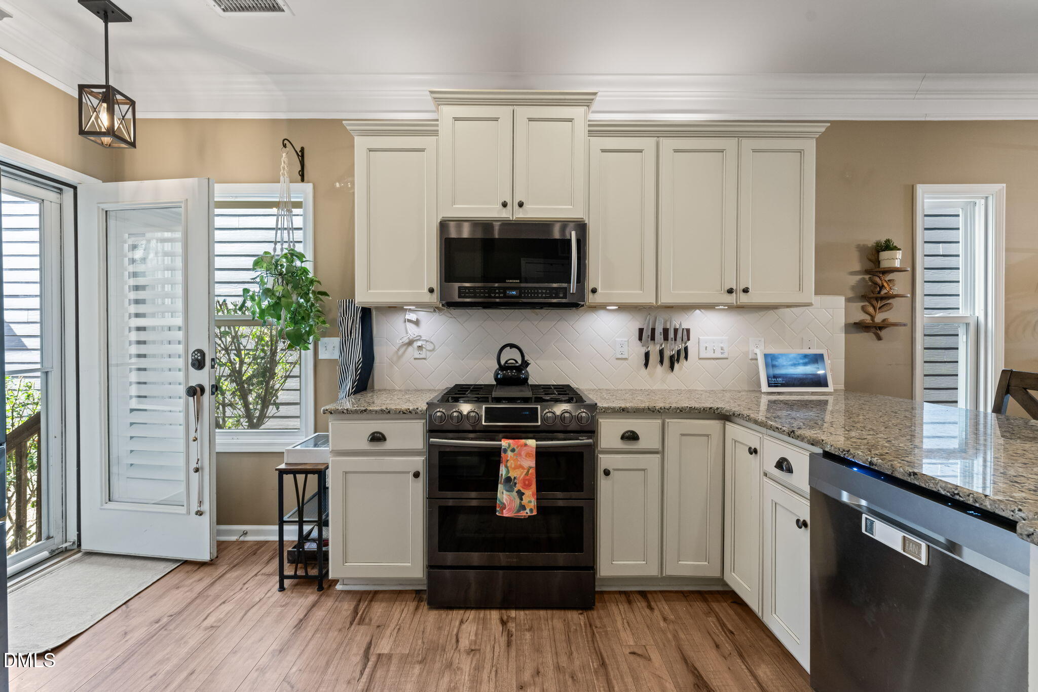 1716 Main Divide Drive Wake Forest, NC 27587 - Photo 13 of 45 a kitchen with stainless steel appliances granite countertop a stove and a sink