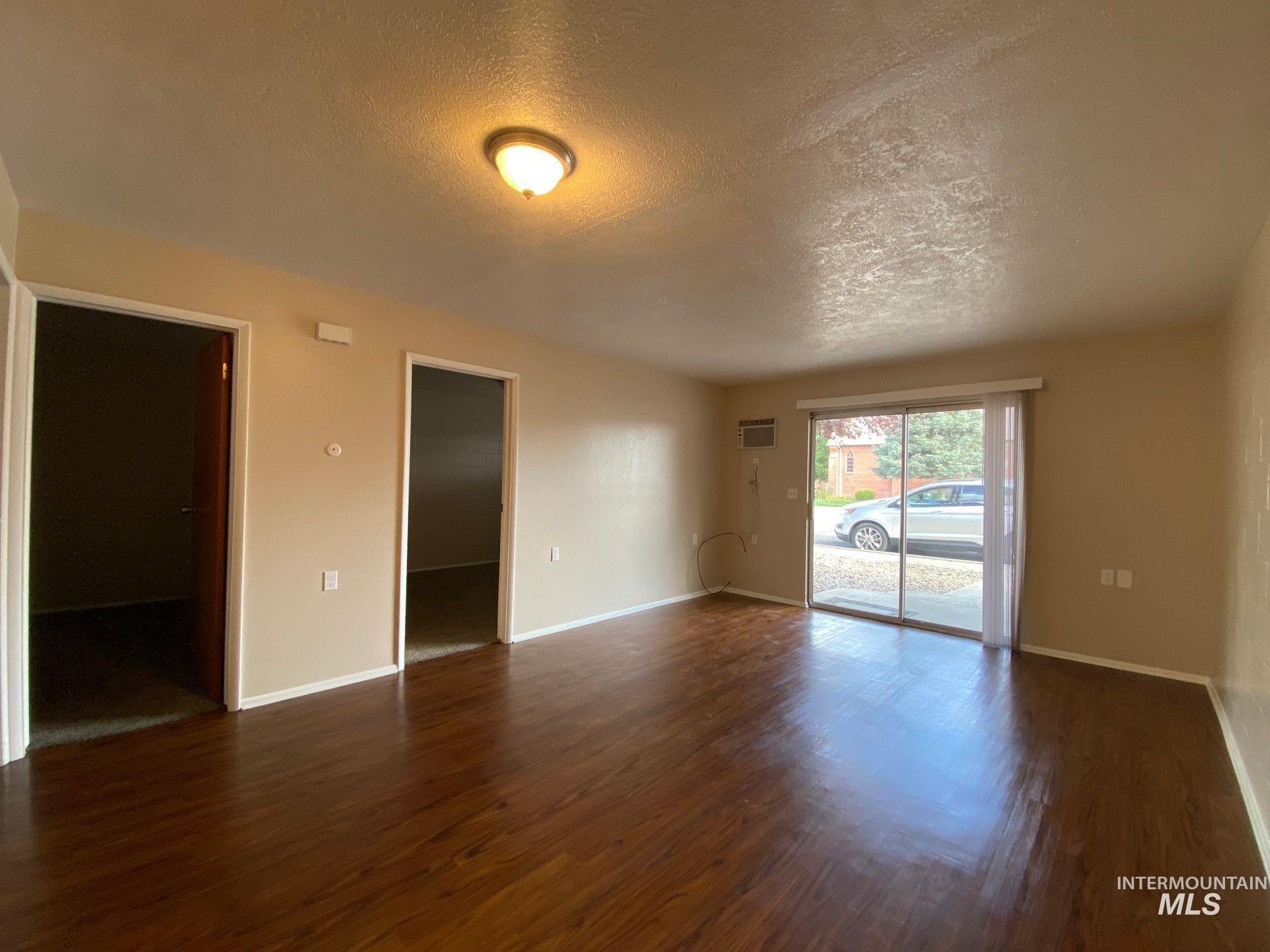 160 Northwest 3rd Street Ontario, OR 97914 - Photo 4 of 4 Unfurnished room with a textured ceiling and dark wood finished floors