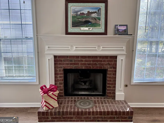 a living room with a fireplace furniture and a window