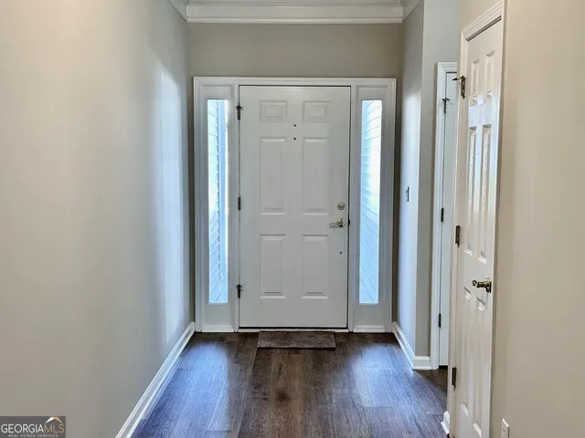 a view of a hallway with wooden floor