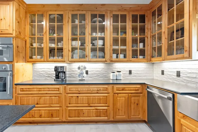 a view of a kitchen with stainless steel appliances granite countertop a sink and cabinets