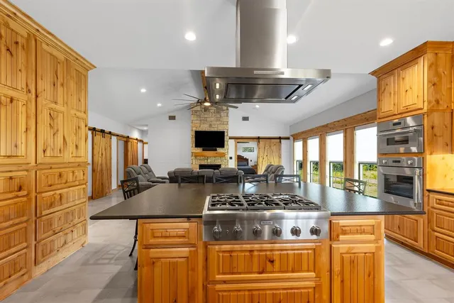 a kitchen with stainless steel appliances granite countertop a stove and a refrigerator